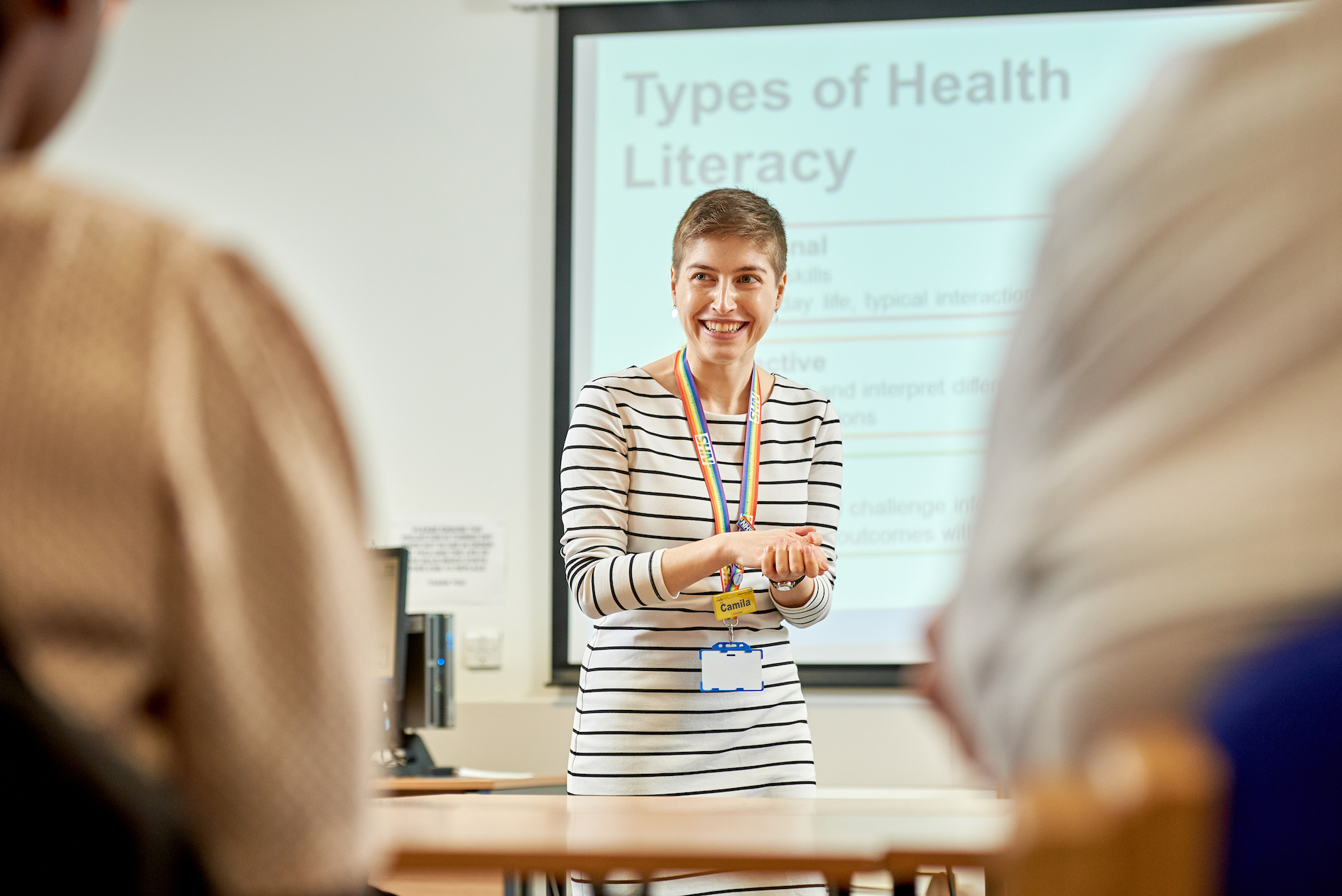 An image of a library professional leading an exercise to a group of people.