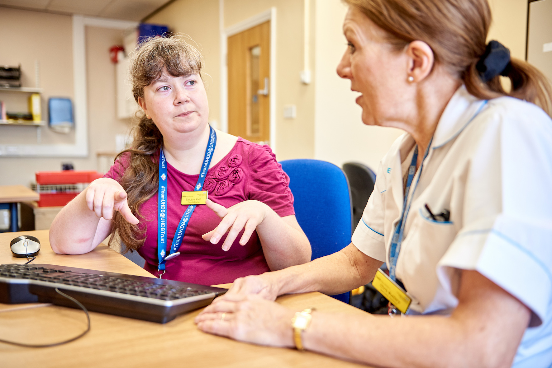 A library professional in discussion with a clinician
