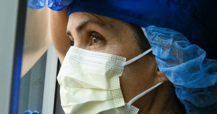 Masked clinician, Image showing a clinician in mask and PPE