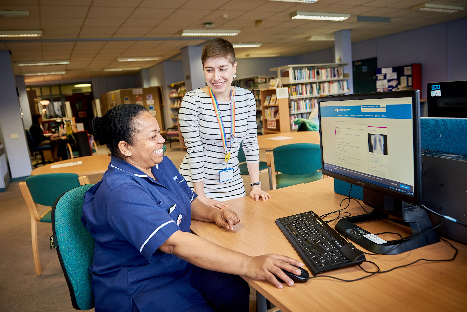 Library professional showing BMJ online to clinician