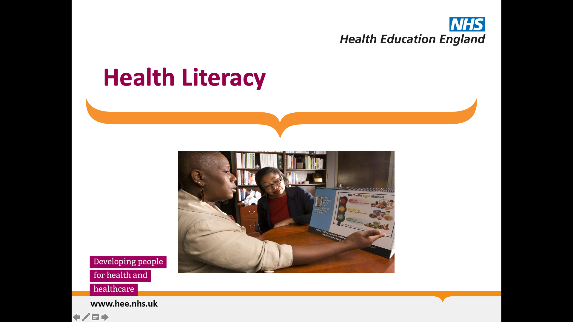 Title: Health Literacy. Image of two library professionals discussing