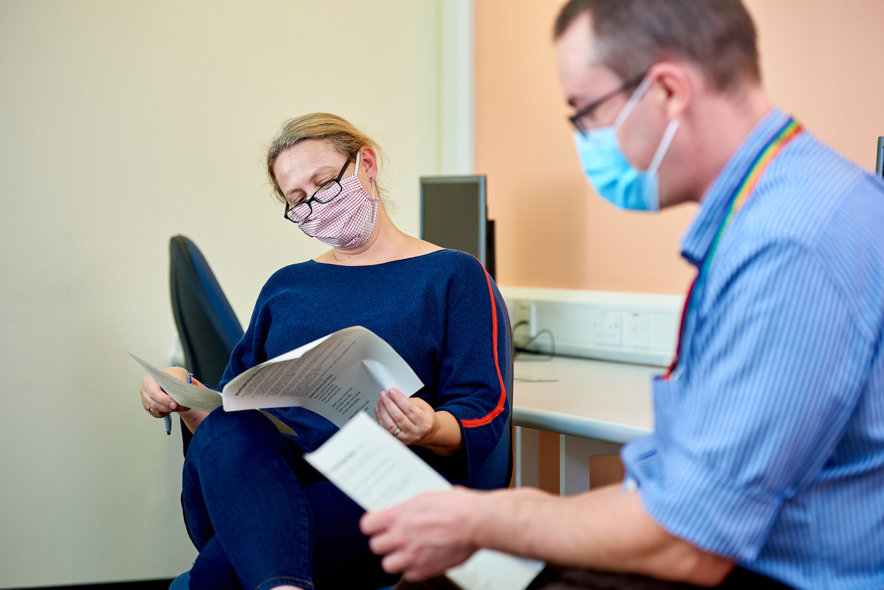 Two clinicians reading documents