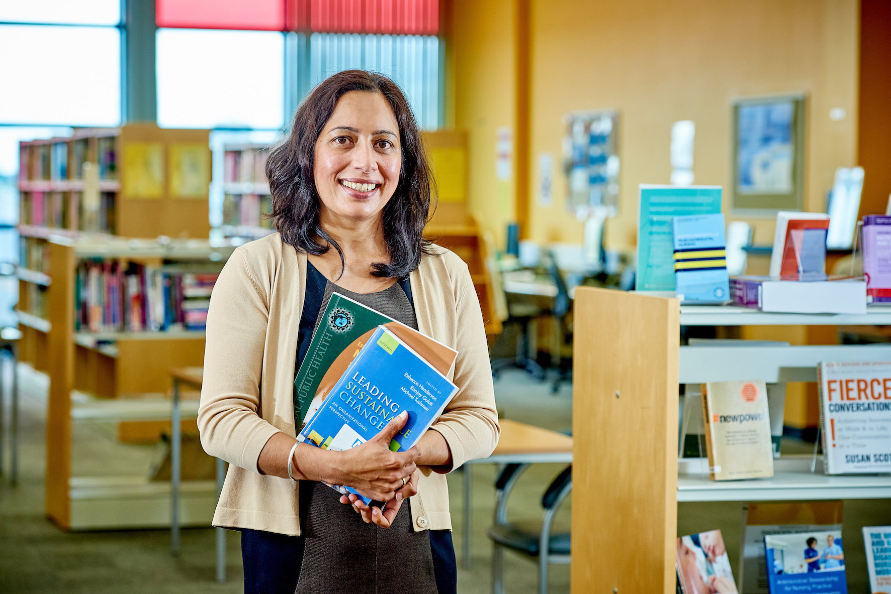 Library professional in front of bookshelves