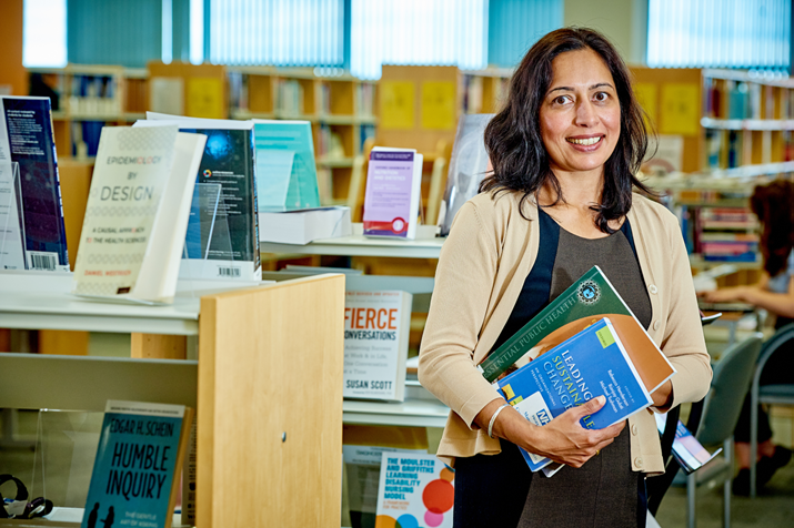 Woman in library holding books